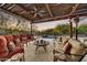 Covered patio with comfortable seating arrangements and a serene view of the pool area at 7304 E Bent Tree Dr, Scottsdale, AZ 85266