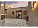 Exterior patio with elegant doors, desert landscaping, and outdoor seating at 7304 E Bent Tree Dr, Scottsdale, AZ 85266