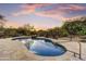 Inviting pool featuring beautiful stone surround and waterfall feature surrounded by desert landscaping at 7304 E Bent Tree Dr, Scottsdale, AZ 85266
