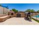 This outdoor patio has a built-in fireplace and outdoor barbeque, ideal for cooking outdoors at 7385 W Honeysuckle Dr, Peoria, AZ 85383
