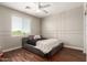 Comfortable bedroom features a modern platform bed, wood floors, and a ceiling fan at 7385 W Honeysuckle Dr, Peoria, AZ 85383