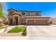 Inviting two-story home featuring a well-maintained lawn and a spacious two-car garage at 7385 W Honeysuckle Dr, Peoria, AZ 85383
