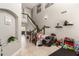 Welcoming foyer with high ceilings, tile flooring, staircase, and playful area at 7385 W Honeysuckle Dr, Peoria, AZ 85383