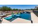 This beautiful in-ground pool and spa have many pool toys and a built-in seating area at 7385 W Honeysuckle Dr, Peoria, AZ 85383