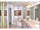 Elegant bathroom featuring a soaking tub, double vanity, and decorative accents at 9130 W Utopia Rd, Peoria, AZ 85382