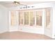 Serene bedroom featuring neutral walls, tile flooring, and a bay window at 9130 W Utopia Rd, Peoria, AZ 85382