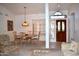 Elegant dining area featuring a hanging light fixture and an entry door with sidelight windows at 9130 W Utopia Rd, Peoria, AZ 85382