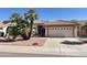 Charming single-story home featuring a well-manicured yard, tile roof, and a two-car garage at 9130 W Utopia Rd, Peoria, AZ 85382