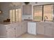 Bright kitchen with updated appliances, neutral countertops, and a window above the sink at 9130 W Utopia Rd, Peoria, AZ 85382