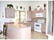 Bright kitchen with updated appliances, neutral countertops, and a window above the sink at 9130 W Utopia Rd, Peoria, AZ 85382