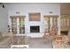 Bright living room boasts a fireplace, French doors, neutral color palette and carpet at 9130 W Utopia Rd, Peoria, AZ 85382