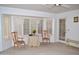 Bright living room with shuttered windows, decorative table, and stylish seating at 9130 W Utopia Rd, Peoria, AZ 85382