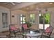 Inviting sunroom with comfortable seating, ceiling fans, and bright natural light at 9130 W Utopia Rd, Peoria, AZ 85382