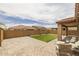 Large backyard with artificial turf, pavers, covered patio, and stylish seating, perfect for relaxing at 9757 E Red Giant Dr, Mesa, AZ 85212