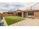 Spacious backyard with artificial turf, pavers, covered patio, seating, and perfect for outdoor entertaining at 9757 E Red Giant Dr, Mesa, AZ 85212