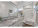 Bright bathroom featuring white cabinets, granite counters, and a shower-tub combo with decorative artwork at 9757 E Red Giant Dr, Mesa, AZ 85212
