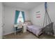 Charming bedroom with a desk, chair, hanging chair, and a window with blue curtains at 9757 E Red Giant Dr, Mesa, AZ 85212