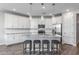 Stylish kitchen boasts granite countertops, subway tile backsplash, modern appliances, and seating at the large center island at 9757 E Red Giant Dr, Mesa, AZ 85212
