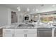 Modern kitchen with an island sink, stainless steel appliances, and a view into the bright, open living space at 9757 E Red Giant Dr, Mesa, AZ 85212