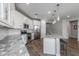Spacious kitchen featuring a large island, stainless steel appliances, and white cabinets for storage at 9757 E Red Giant Dr, Mesa, AZ 85212