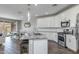 Open-concept kitchen with a large island, granite countertops, stainless steel appliances, and white cabinetry at 9757 E Red Giant Dr, Mesa, AZ 85212