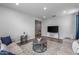 Spacious living room with tile flooring, TV, and stylish furnishings create an inviting atmosphere at 9757 E Red Giant Dr, Mesa, AZ 85212