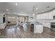 Open-concept living area features a breakfast bar, granite countertops, stainless appliances and a spacious living area at 9757 E Red Giant Dr, Mesa, AZ 85212