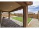 Covered patio overlooking a backyard with artificial turf, pavers, and a gravel side yard at 9757 E Red Giant Dr, Mesa, AZ 85212