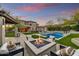 Expansive backyard with a pool, fire pit, and covered patio, perfect for outdoor entertaining and relaxation at 9939 E Desert Jewel Dr, Scottsdale, AZ 85255