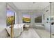 Modern bathroom showcasing a soaking tub, separate glass shower, and scenic views from multiple windows at 9939 E Desert Jewel Dr, Scottsdale, AZ 85255