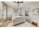 Bright bedroom with white furniture, a stylish butterfly art piece, and a window with sunset views at 9939 E Desert Jewel Dr, Scottsdale, AZ 85255