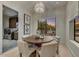 Chic dining area with a stylish chandelier, backyard views, and adjacent laundry room with modern machines at 9939 E Desert Jewel Dr, Scottsdale, AZ 85255