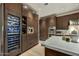 Gourmet kitchen with custom cabinetry, a wine fridge, modern appliances, and elegant countertops for culinary enthusiasts at 9939 E Desert Jewel Dr, Scottsdale, AZ 85255