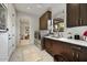 Well-organized laundry room with modern appliances, dark cabinetry, and ample counter space at 9939 E Desert Jewel Dr, Scottsdale, AZ 85255