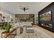 Expansive living room featuring a modern fireplace, comfortable seating, and seamless indoor-outdoor living at 9939 E Desert Jewel Dr, Scottsdale, AZ 85255