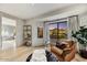 Bright living room featuring comfortable seating and a beautiful mountain view through a large window at 9939 E Desert Jewel Dr, Scottsdale, AZ 85255
