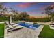 Relaxing poolside featuring comfortable lounge chairs, well-maintained turf, and a peaceful ambiance at 9939 E Desert Jewel Dr, Scottsdale, AZ 85255