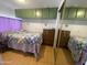 Comfortable bedroom with green cabinets, a mirrored closet, and a cozy bed at 1004 S Kiowa Cir, Apache Junction, AZ 85119