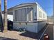 Exterior view of the home showing the front windows and some gravel landscaping at 1004 S Kiowa Cir, Apache Junction, AZ 85119