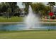 Beautiful golf course with water feature and lush green grass, creating a serene atmosphere for recreation at 1004 S Kiowa Cir, Apache Junction, AZ 85119