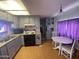Cozy kitchen with gray cabinets, wood flooring, and a dining table area at 1004 S Kiowa Cir, Apache Junction, AZ 85119