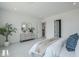 Bright bedroom features dresser, tile floors, and a stylish upholstered bed with decorative pillows at 11045 N Hershey St, Surprise, AZ 85388