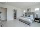 Bright primary bedroom features ensuite bath access, tile floors, and a stylish upholstered bed with a padded headboard at 11045 N Hershey St, Surprise, AZ 85388