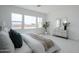 Bright bedroom features large windows, tile floors, dresser, and a stylish upholstered bed with decorative pillows at 11045 N Hershey St, Surprise, AZ 85388