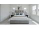 Bright bedroom features large windows, tile floors, and a stylish upholstered bed with a padded headboard at 11045 N Hershey St, Surprise, AZ 85388