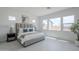 Bright bedroom features large windows, tile floors, and a stylish upholstered bed with a padded headboard at 11045 N Hershey St, Surprise, AZ 85388