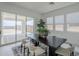 Bright dining room with modern table and chairs, and sliding glass doors to the backyard at 11045 N Hershey St, Surprise, AZ 85388