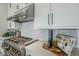 Gourmet kitchen featuring stainless steel gas range, custom cabinets, and modern backsplash at 11045 N Hershey St, Surprise, AZ 85388