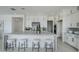 Stylish kitchen island with seating, white cabinets, and stainless steel appliances at 11045 N Hershey St, Surprise, AZ 85388