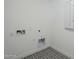 Small, simple Laundry Room with pattern-tile flooring and white walls at 11045 N Hershey St, Surprise, AZ 85388